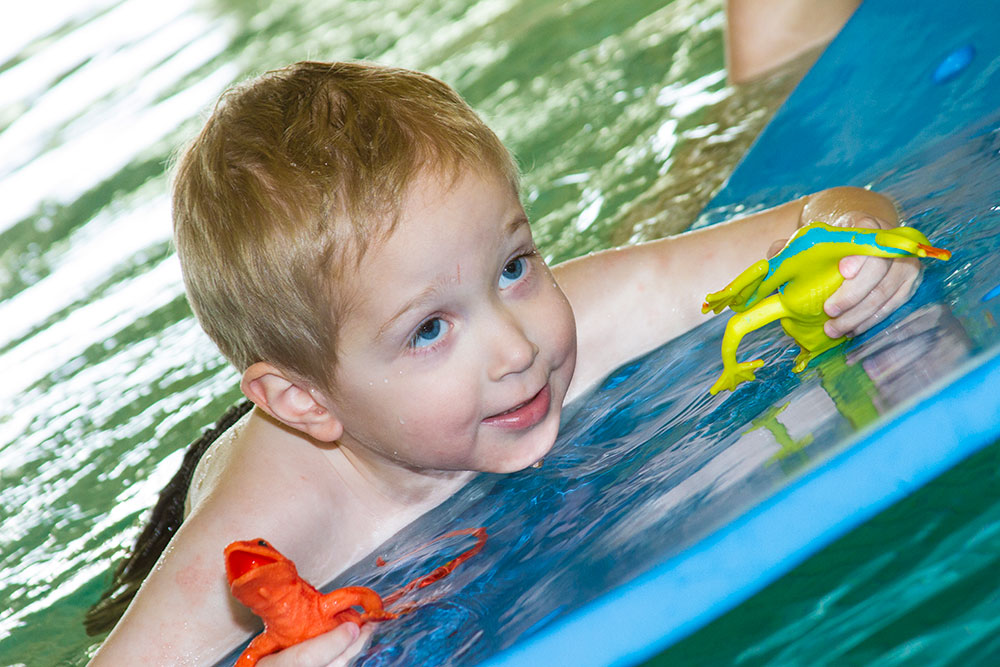boy on a float in a swimming pool | aquatic therapy