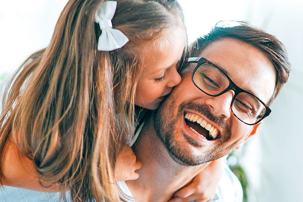 Little Girl kissing her dad